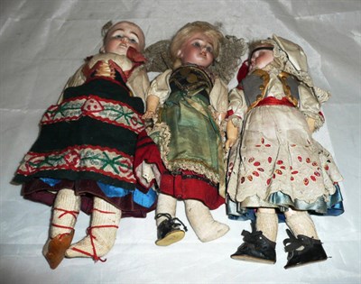 Lot 239 - Three bisque socket head dolls, all dressed in national costumes