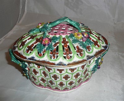 Lot 277 - A Caughley porcelain flower encrusted chestnut basket and cover with clobbered decoration (a.f.)