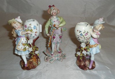 Lot 284 - A pair of German porcelain figural posy vases and a German porcelain figure of a gallant (all a.f.)