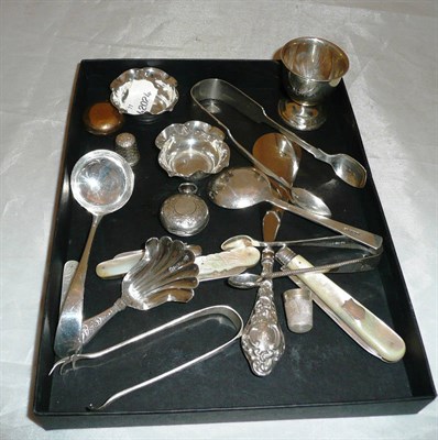 Lot 309 - A quantity of small silver items including four fruit knives, three sets of tongs, egg cup etc..