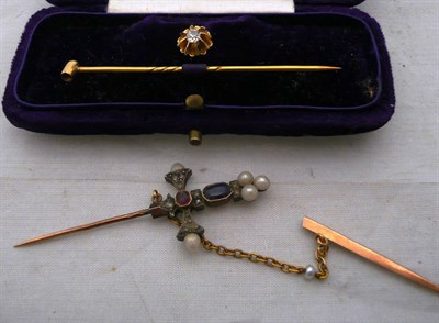 Lot 321 - A diamond set stud and pin and a gem set sword pin