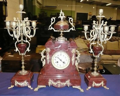 Lot 358 - A marble striking mantel clock with garniture