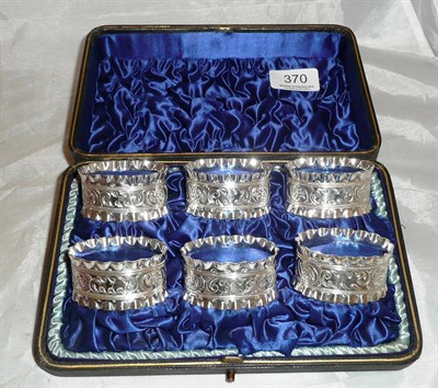 Lot 370 - Six silver plated napkin rings, boxed