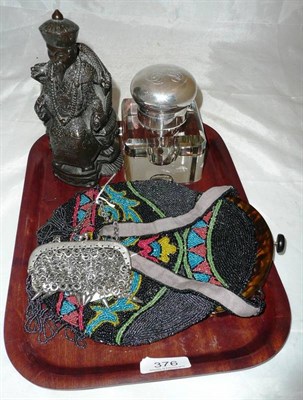 Lot 376 - A resin Buddha a beadwork evening bag, a silver mounted inkwell and a purse