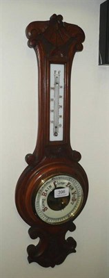 Lot 396 - A carved oak aneroid barometer