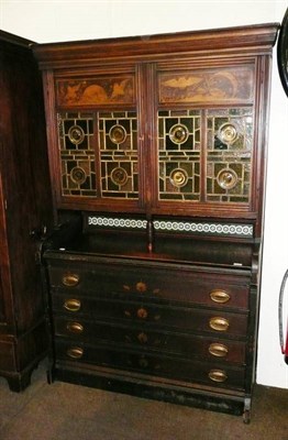 Lot 534 - An Aesthetic movement walnut cabinet with leaded and stained glass upper section