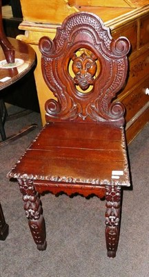 Lot 550 - A carved oak hall chair