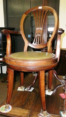 Lot 559 - A swivel chair with green studded seat