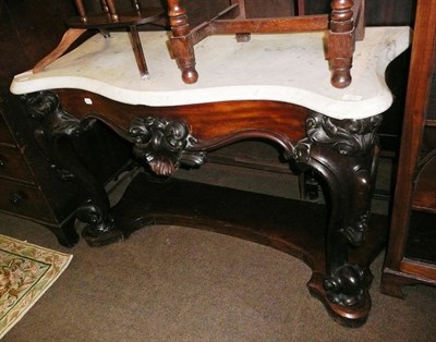 Lot 571 - A Victorian carved mahogany and marble top console table