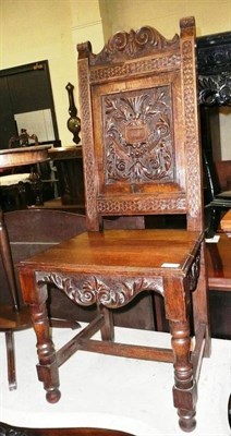 Lot 572 - A carved oak hall chair