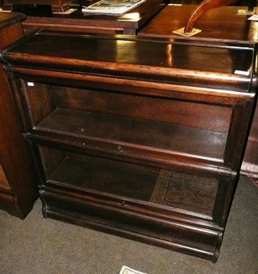 Lot 579 - An oak two section bookcase