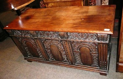 Lot 581 - An oak coffer with carved decoration