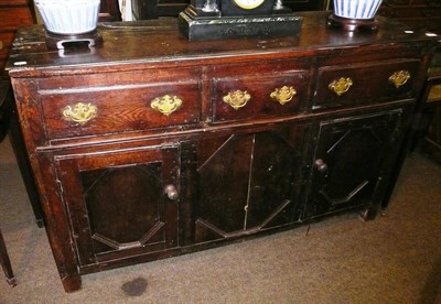 Lot 597 - An 18th century oak enclosed dresser