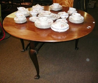 Lot 601 - A walnut drop leaf table on trefid feet