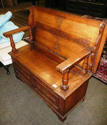 Lot 618 - A carved oak monks bench