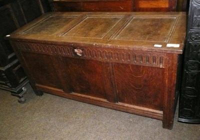 Lot 642 - An 18th century oak coffer with carved frieze