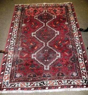 Lot 651 - A Kashgai rug South west Persia The abrashed field with triple linked medallions enclosed by narrow