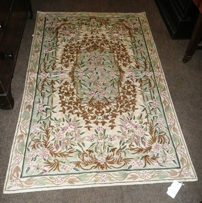 Lot 652 - A Kashmir chain stitch rug North west India The ivory field of vines around a mint green...