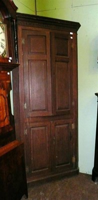 Lot 679 - The front section of a Georgian oak floor standing corner cupboard