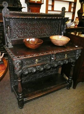 Lot 694 - A carved oak sideboard