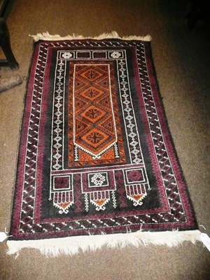 Lot 699 - A Balouch Prayer Rug Persian/Afghan Frontier The burnt orange field of hooked medallions...