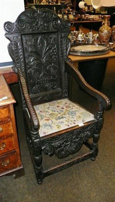 Lot 701 - A carved oak open armchair