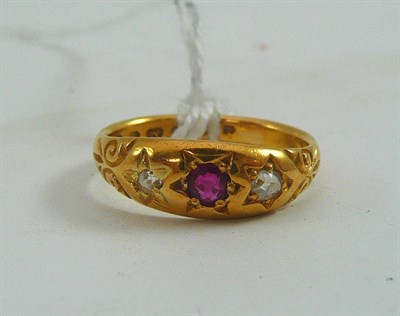 Lot 54 - A 22ct gold ruby and diamond three stone ring