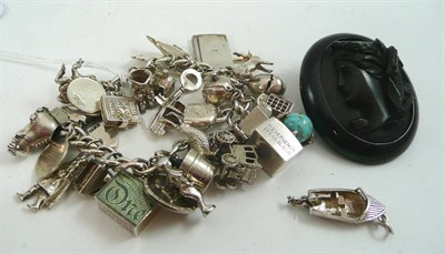 Lot 84 - A silver charm bracelet, loose charms and a jet brooch