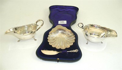 Lot 145 - Presentation silver shell butter dish and two silver sauce boats