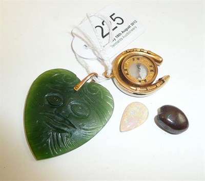 Lot 225 - A jade pendant, an opal stone and a compass pendant