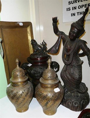 Lot 257 - A Burmese carved wooden figure of a deity, a pair of Benares brass vases and cover and a tray and a