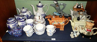 Lot 264 - Seven novelty teapots, Ringtons blue and white, tea sets etc (on a shelf and in two boxes)