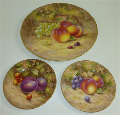 Lot 287 - A Worcester fruit painted plate by H Ayrton and two saucers by Freeman