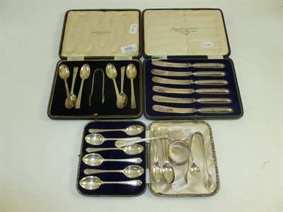 Lot 300 - Cased set of silver golf teaspoons, another six golf teaspoons, cased set of spoons and tongs,...