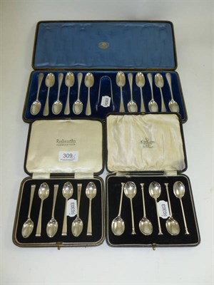 Lot 309 - Two cased sets of six silver coffee and teaspoons, and a cased set of twelve spoons with tongs