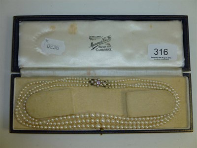 Lot 316 - Three strand pearl necklace in blue box