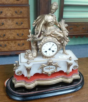 Lot 335 - A French striking gilt metal and onyx mantel clock