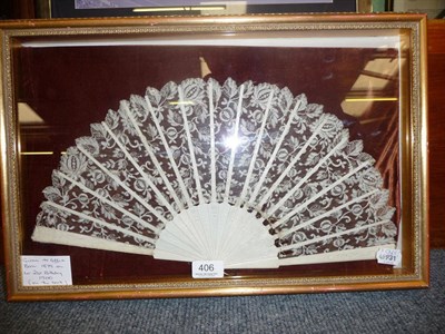 Lot 406 - A brisé fan with lace leaf, in a glazed case