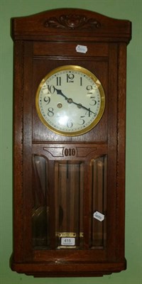 Lot 415 - An oak cased wall clock