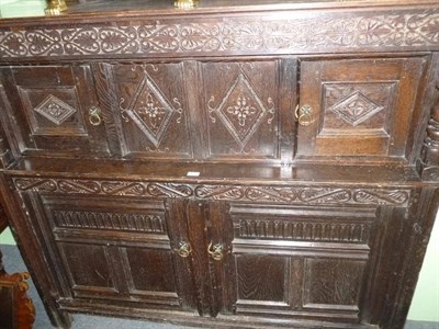 Lot 417 - A late 17th century carved oak panelled court cupboard