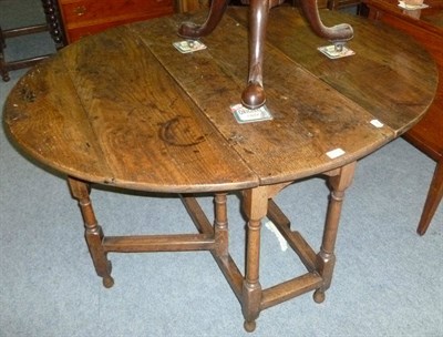 Lot 505 - An oak gate leg table with drawer