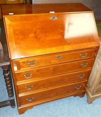 Lot 517 - A reproduction desk, yew open bookcase, bureau and Sutherland table