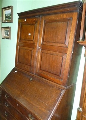 Lot 557 - An early 19th century oak bureau bookcase