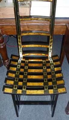 Lot 564 - Pair of black lacquered and gilt decorated decorative ladder back hall chairs from Ho Chi Minh City