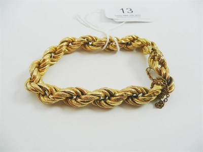 Lot 13 - # A hollow rope twist bracelet, with plain and textured yellow links, length 20cm