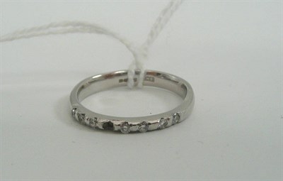 Lot 22 - A platinum diamond set band ring (one stone missing)