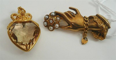 Lot 45 - # A 15ct gold brooch as a lady's hand holding a flower, set with split pearls and diamonds,...