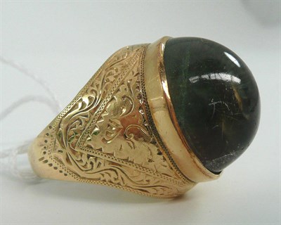 Lot 47 - # A college ring, set with large central cabochon stone, on engraved shoulders, finger size W