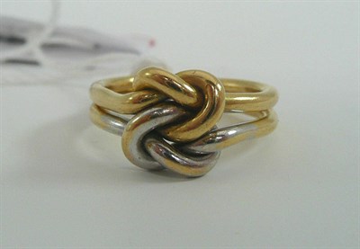 Lot 48 - # An 18ct gold two colour knot ring, one knot in white, one in yellow, entwined, with a double...