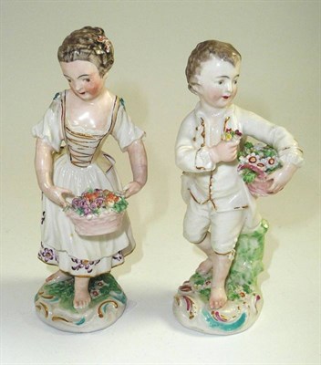 Lot 73 - # A pair of Derby porcelain figures of a boy and girl, late 18th century, each holding a basket...
